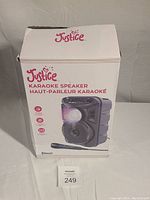 Photo of the Justice Karaoke Speaker in its original box showing the product image and branding.