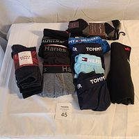 Overview of the men's underwear and socks showing different brands and colors, some still in factory packaging.