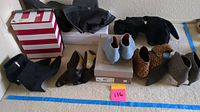 Full view of six pairs of women's boots of various styles and colors, sizes 9 or 9.5.