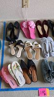 Photo showing variety of footwear including flats, flip-flops, slippers and sandals in different colors and styles as part of the lot.