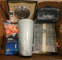 Multiple items in a box including Harley-Davidson accessory, Shopko case, InkTec ink cartridge, orange rings, galvanized metal vase, plastic organizer box