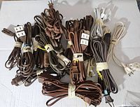 Top view showing all 16 extension cords in bundles, various colors and two-outlet designs.