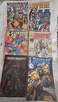 Two rows of assorted comic books showing covers from series including StormQuest, Supreme, Superman, Brigade, and Cy-Gor.