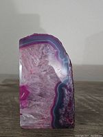 Front view of pink and purple agate geode crystal highlighting its bright colors and crystal interior.