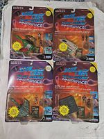 Four sealed blister packs featuring different Star Trek Next Generation Innerspace mini playsets with starship models and character figures.