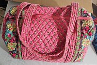 Top and side view of pink quilted Vera Bradley tote bag showing floral patterns and shoulder straps.