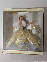 Full view of Celebration Teresa Barbie in original box with gold gown, fur stole, holding ornament