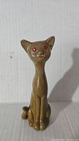 Front angle photo of vintage faux wood Siamese cat figurine showing full body and face