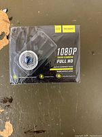 Photo of the front of the box showing the dash camera image, brand, model number, and features including 1080P full HD, ultra compact size, wide angle lens, night vision, and FHD traffic mode recording.