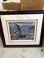 Front view of framed abstract seascape print with cream mat and gold liner, dark wood frame