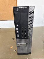 Front view of Dell OptiPlex 9020 computer tower showing DVD drive, USB ports, and audio jacks.