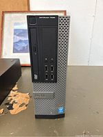Front view of Dell OptiPlex 7010 computer tower showing DVD drive, power button, audio jacks, USB ports and Dell logo.
