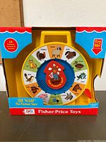Front view of Fisher Price See 'N Say toy still in original packaging, showing animal images and Fisher Price branding.