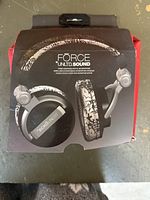 Front view of original packaging showing headphones and microphone with branding visible.