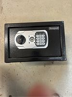Front view of Honeywell mini safe showing electronic keypad, key lock, and handle.