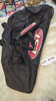 Black Easton baseball bag lying flat showing front, large Easton and N3T logos, side pockets, and shoulder strap.