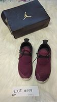 Pair of burgundy Air Jordan sneakers with box