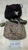 Overview of both Disney bags: black Tinkerbell backpack and green Mickey Mouse crossbody bag