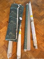 Overview of all fabric bolts and cut pieces laid out on floor