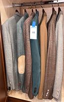 Group shot of seven hanging blazers and sport coats