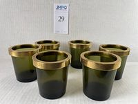 Set of six green glass candle holders with brass rings, arranged on a white background showing all items.
