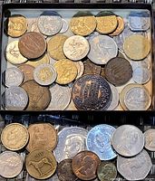 Photo showing a variety of vintage coins with different sizes and designs in assorted metals including silver, bronze, and copper.