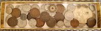 Wide view of the assortment of vintage and antique Asian coins in various sizes and conditions, showing coins with holes and intricate designs including calligraphy characters.