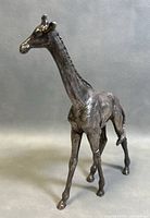 Front angled view of vintage sterling silver giraffe statue showing detailed facial features and textured body.