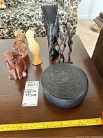 Overview of Argillite box and six figurines arranged on table