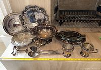 Full view of the electroplated serveware including trays, bowls, creamer, sugar bowl, and utensils displayed on table with ruler for size reference