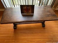 Top-down view of the rectangular wooden coffee table showing surface wear and scratches