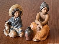 Front view showing both figurines and vase