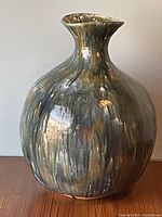 Front and side view of glazed pottery vase showing glaze colors and texture.