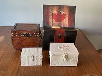 Four unique storage and trinket boxes, various materials and sizes, displayed on table.