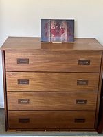 Front view of dresser showing all four drawers and recessed handles