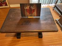 Top view of the rectangular wooden side table showing surface scratches and wear