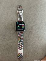 Apple Watch Series 6 on patterned silicone band displaying home screen