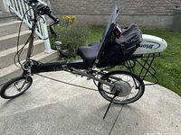 Side view of aluminum recumbent frame, front and rear wheels, seat and battery pack