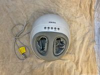 Top view of the Homedics foot massager showing foot openings, control buttons, and power cord