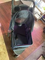 Top down view of blue pet stroller showing open mesh sun shade and interior leash clip