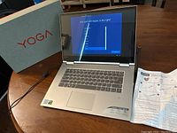 Lenovo Yoga 730 laptop open with original box, pen and manual sheet