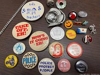 Overview of the vintage pins collection showing various pins with cultural and police themes from 1980s Toronto and Scarborough.