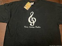 Black Hatley cap sleeved t-shirt with 'Here Comes Treble' treble clef music graphic, size XL, new with tags.