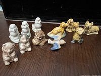 Photo of all 12 Wade china animal figurines including dogs, kittens, and bird