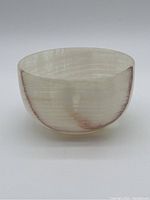 Full side profile of the onyx bowl showing natural banding and colors.