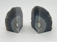 Front view of the polished sides of the geode bookends showing detailed banding patterns and symmetrical shapes.