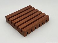 Front angled view of the solid mahogany trivet, showing the parallel slat design and rectangular shape.