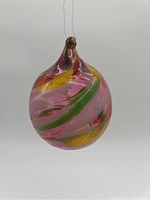 Front angle of a 4 inch multicolor swirled glass hanging bauble suspended by a wire.