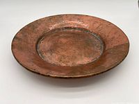 Top down view of large solid copper tray showing worn copper surface and patina.