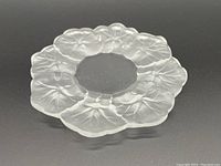 Top angle view showing the frosted crystal pansy design around the rim and the clear center of the plate.